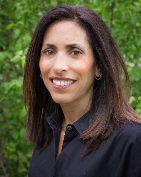 A woman with long hair wearing a black shirt.